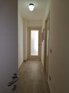 an empty hallway with a door with a light in it at Akron B&B in SantʼAlessio Siculo