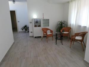 a room with chairs and a table and a refrigerator at Akron B&B in SantʼAlessio Siculo