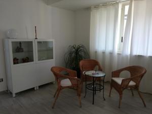 a room with chairs and a table and a cabinet at Akron B&B in SantʼAlessio Siculo