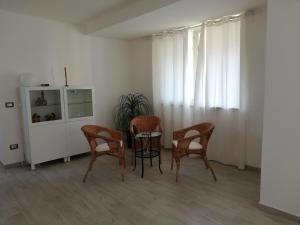 a dining room with a table and chairs and a window at Akron B&B in SantʼAlessio Siculo