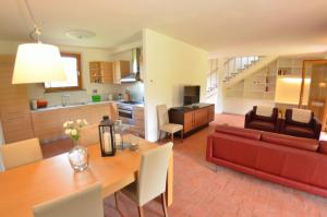 a living room and kitchen with a red couch and a table at Il Sogno Tra I Vigneti in Montecarlo