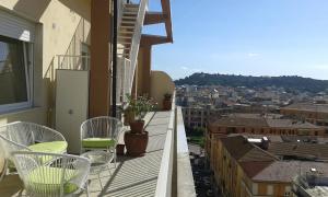a balcony with chairs and a view of a city at Manzoni Suite in Cagliari