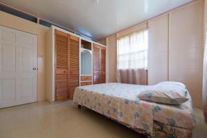 a bedroom with a bed and a large window at T.Cole’s Holiday Rental in Saint James