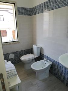 a bathroom with a toilet and a sink at Akron B&B in SantʼAlessio Siculo