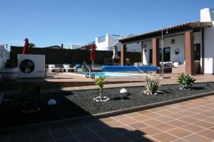 a house with a swimming pool with a pool at VILLA DREAMS - VILLAS LA ESTANCIA - in Caleta De Fuste