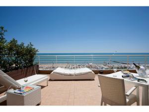 a patio with a view of the beach and the ocean at Hotel Aurora in Lido di Jesolo