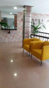 a lobby with yellow couches in a building at Hostal Residencia Cardona in Arrecife