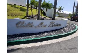 a sign for a building on a street at Beautiful Villa at The Rio Mar Beach Resort in Rio Grande