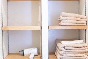 two pictures of a bathroom closet with towels at Guest House Re-worth Yabacho1 202 in Nagoya +15 photos