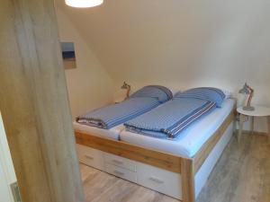 ein Schlafzimmer mit einem Bett mit blauen Kissen darauf in der Unterkunft Ferienwohnung Dawe in Göttingen