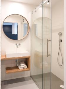 a bathroom with a sink and a mirror at Ataner Apartamenty in Koszalin