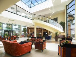 a lobby with couches and chairs in a building at Kinsale Hotel & Spa in Kinsale