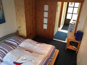 a bedroom with a bed with a boat on it at Smans Fewo in Neustadt in Holstein