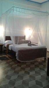 A bed or beds in a room at Sun View Resort Kithalella