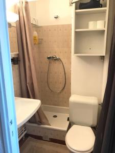 a bathroom with a shower and a toilet and a sink at Boost Your Immo Centre Vars 58 in Vars
