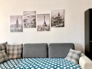 a living room with a couch and some pictures on the wall at Zg Zapad in Zagreb