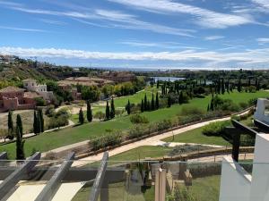 a view of a golf course from the balcony of a house at Los Flamingos Tee 6 in Estepona