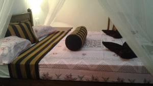 A bed or beds in a room at Sun View Resort Kithalella