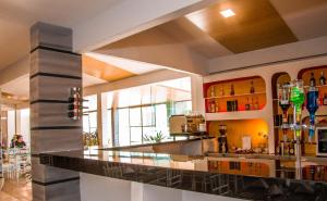 a large kitchen with a bar in a building at Hotel Regina Resort & Convenciones in Cochabamba