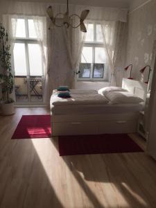 a bedroom with a large bed with a window at Appartement am Tegeler See in Berlin