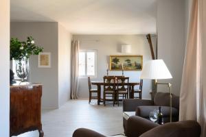 a living room with a couch and a table at Le Mille e una Notte EXCLUSIVE SUITE FIRENZE in Florence