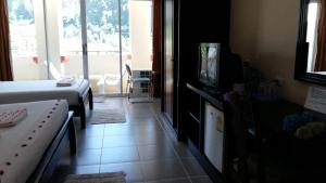 a hotel room with a bed and a television at Number 1 Guesthouse in Ao Nang Beach