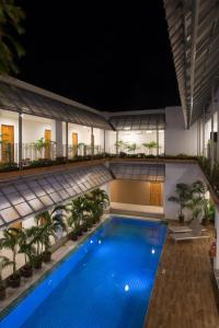 uma piscina no meio de um edifício à noite em Nonnee Hotel Kata Beach Phuket em Praia de Kata