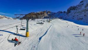 a group of people riding a ski lift in the snow at Lullaby B&B in Ballabio