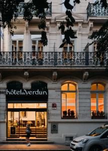 a large building with a sign on the front of it at Hotel De Verdun 1882, BW Signature Collection in Lyon