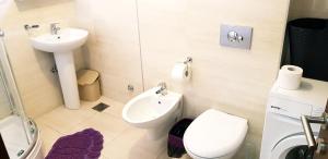 a bathroom with a toilet and a sink at Olimp Lux in Budva +48 photos