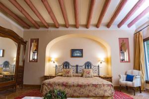 a bedroom with a large bed in a room at Hacienda de Orán in Utrera