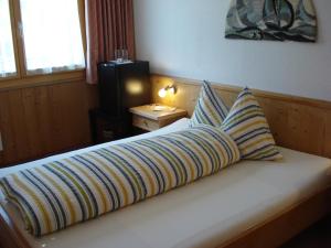 a bedroom with a bed with two pillows on it at Hotel Bahnhof in Reichenbach