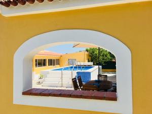 an archway of a house with a swimming pool at O Nosso Cantinho - Private Property & Pool in Casais da Carneiria