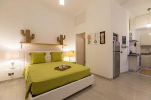a bedroom with a green bed and a refrigerator at Lovely New home, Trastevere! in Rome