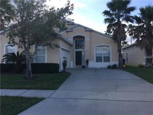 a white house with palm trees and a driveway at Orlando Discount Villas - Davenport in Davenport