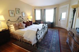 a bedroom with a large bed and a large window at Inn at 835 Boutique Hotel in Springfield