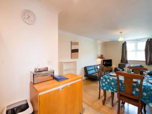 a living room with a table and a dining room at Long Stay Reduced Rates 3P in Manchester