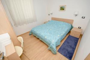 a small bedroom with a bed with a blue blanket at Villa Danex Superior in Umag +35 photos
