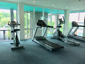 a gym with three cardio machines in a room at Baan Kun Koey Condo Huahin B103,Pool View,Heart of Huahin,Near Blue Ports,300m from Beach in Hua Hin