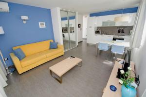 a living room with a yellow couch and a table at Villa Danex Superior in Umag