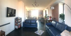 a living room with a couch and a dining room at Castello D'Alcontres Guest House 3 stelle in Nizza di Sicilia