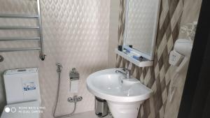 a small bathroom with a sink and a toilet at Evim Otel in Zaqatala +78 photos