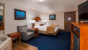 a hotel room with a bed and a bathroom at Best Western Valdez Harbor Inn in Valdez