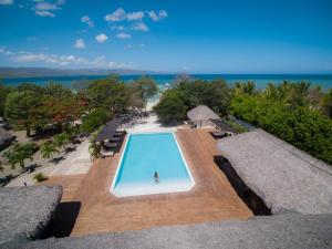 an overhead view of a person in a swimming pool at Punta Rucia Lodge Hotel Boutique & Spa in Punta Rucia