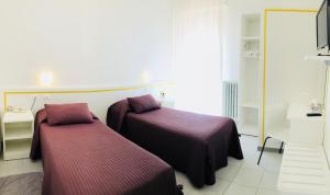 Llit o llits en una habitació de Albergo Ester