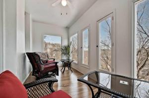 a living room with two chairs and windows at New Orleans Hotel Eureka Springs in Eureka Springs