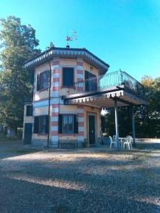 a house with a balcony and a deck on it at Agriturismo Villa Brugolta in Lavena Ponte Tresa