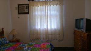 a bedroom with a bed and a window with a television at Casa Condominio Fechado Total Segurança - Juquehy in Juquei +20 photos