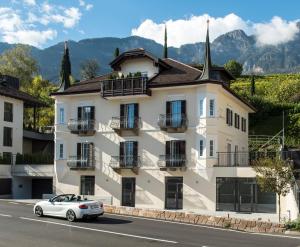 a white car parked in front of a building at Villa Caldarum in Caldaro