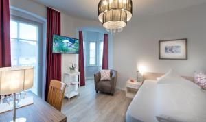 a bedroom with a bed and a table and a chair at Villa Caldarum in Caldaro